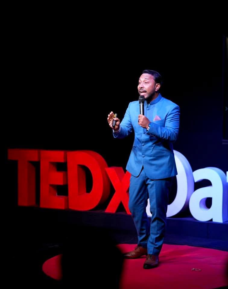 Shuvasish Bhowmick speaking on stage
